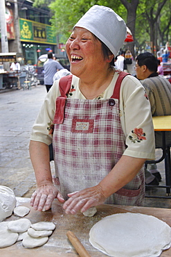 Woman making bread in the Muslim quarter of Xi'an, China, Asia