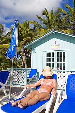 Beach cabana and woman, Princess Cays, Eleuthera Island, Bahamas, West Indies, Central America