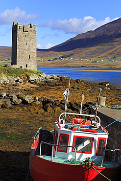 Kildownet Castle and fishing boat on Achill Island, County Mayo, Connaught (Connacht), Republic of Ireland, Europe