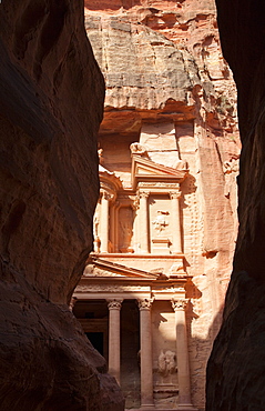 The facade of the Treasury (Al Khazneh) carved into the red rock, seen from the Siq, Petra, UNESCO World Heritage Site, Jordan, Middle East