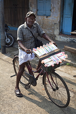 A lottery ticket seller on his bicycle in Kochi (Cochin), Kerala, India, Asia 