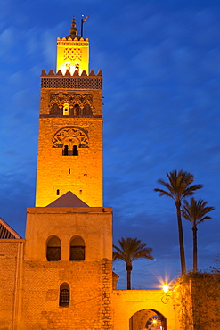 The Minaret of the Koutoubia Mosque illuminated at dusk with palm trees, UNESCO World Heritage Site, Marrakech, Morocco, North Africa, Africa