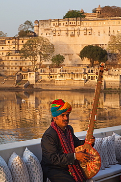 Man playing a traditional Tambura at Lake Palace Hotel in Udaipur, Rajasthan, India, Asia