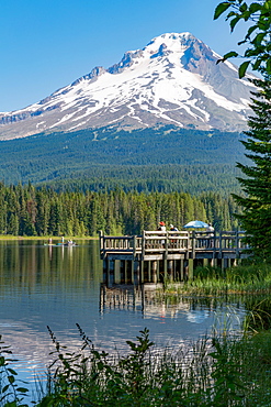 Fishing on Trillium Lake with Mount Hood, part of the Cascade Range, reflected in the still waters, Oregon, United States of America, North America