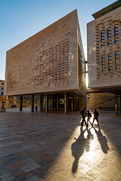 People walking past Parliament House on Freedom Square in Valletta, Malta, Europe