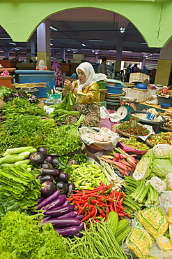 Women selling fruit and vegetables in the town's central market, Kota Bharu, Kelantan State, Malaysia, Southeast Asia, Asia 