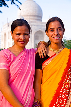 Two women pose in front of the Taj Mahal, UNESCO World Heritage Site, Agra, Uttar Pradesh, India, Asia