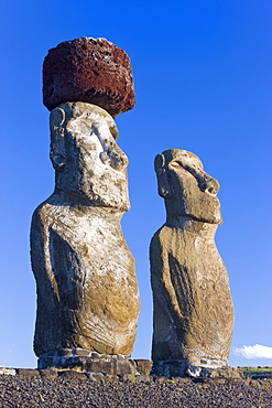 Ahu Tongariki, the largest ahu on the Island, two of the Tongariki row of 15 giant Moai statues, only this one still has a topknot in place, Rapa Nui (Easter Island), Chile, South America