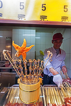 Scorpions, seahorses, starfish and other delicacies on skewers for sale at Wangfujing Street night market, Beijing, China, Asia