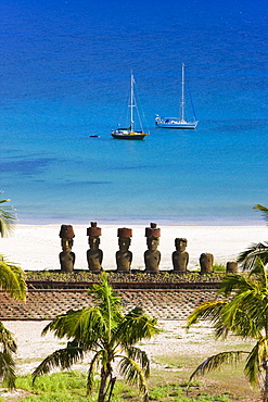 Anakena beach, yachts moored in front of the monolithic giant stone Moai statues of Ahu Nau Nau, four of which have topknots, Rapa Nui (Easter Island), UNESCO World Heritage Site, Chile, South America