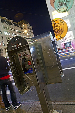 Pay phone and shop windows on Fifth Avenue at night, Manhattan, New York City, New York, United States of America, North America