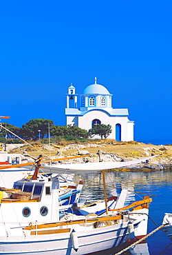 Fishing boats with a chapel in background, Chios Island, Greek Islands, Greece, Europe