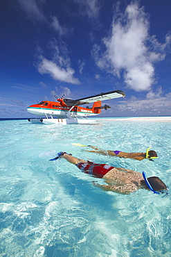 Seaplane and couple snorkeling, Maldives, Indian Ocean, Asia