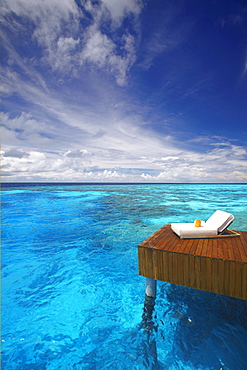 Sun lounger and jetty in blue lagoon, Maldives, Indian Ocean, Asia