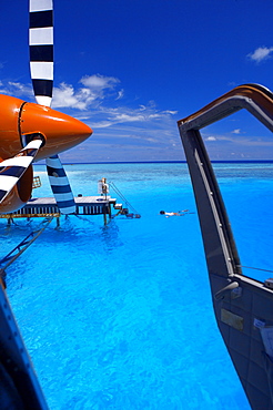 View from a seaplane cockpit of man swimming, Maldives, Indian Ocean, Asia