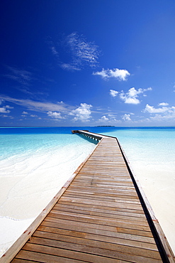 Wooden jetty out to tropical sea, Maldives, Indian Ocean, Asia