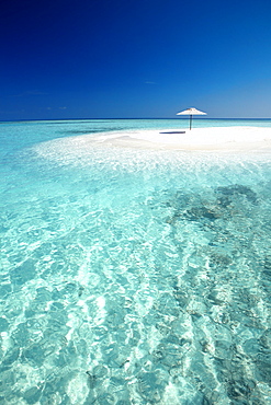 Tropical sandbank and sun umbrella, Maldives, Indian Ocean, Asia