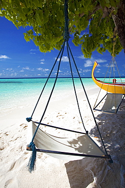 Swing and traditional boat on tropical beach, Maldives, Indian Ocean, Asia