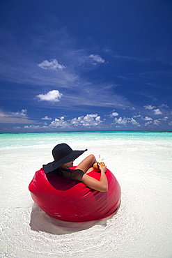 Woman relaxing on the beach, Maldives, Indian Ocean, Asia