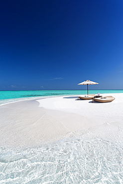 Two lounge chairs with sun umbrella on a tropical beach, The Maldives, Indian Ocean, Asia