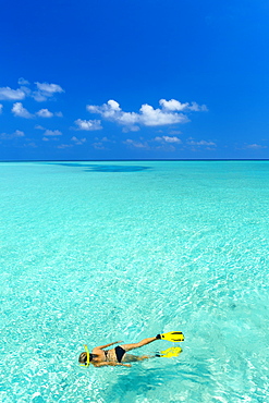 Young woman snorkelling in Maldives, Indian Ocean