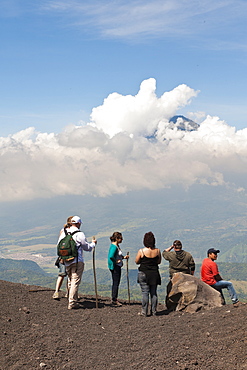 Climbing Pacaya volcano, with Fuego Volcano in distance Antigua, Guatemala, Central America