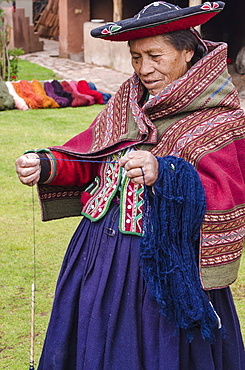 Inca woman spins yarn in Chinchero, Peru, South America