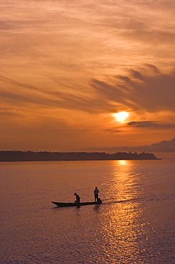 Fishermen at sunset on the Amazon River, Brazil, South America