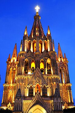 Mexico, Bajio, San Miguel de Allende, La Parroquia church neo-gothic exterior illuminated at night.