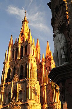 Mexico, Bajio, San Miguel de Allende, La Parroquia de San Miguel Arcangel neo-gothic exterior with statue of Ignacio Allende in foreground.