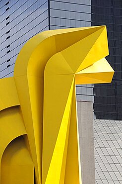 Mexico, Federal District, Mexico City, Detail of yellow Little Horse sculptural form in front of mirrored exterior of Torre Caballito on Reforma.