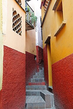 Mexico, Bajio, Guanajuato, Callejon del Beso Narrow street with steep flight of steps ascending between painted building exteriors.