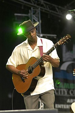 England, Cambridgeshire, Cambridge, Folk Festival Eric Bibb performing on stage with acoustic guitar.