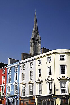 Ireland, County Cork, Cobh, St Colmans Cathedral overlooking colourful houses.