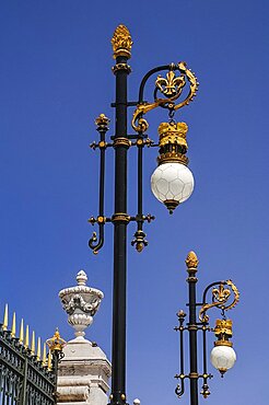 Spain, Madrid, Palacio Real ornate golden lamps at the entrance to the Royal Palace.