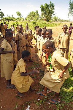 Burundi, Cibitoke Province, Buganda, Ruhagurika Primary School girls dancing during their playtime outside Catch-Up Class in Buganda Commune. Catch up classes were established by Concern Worldwide across a number of schools to provide a second chance for children who had dropped out.