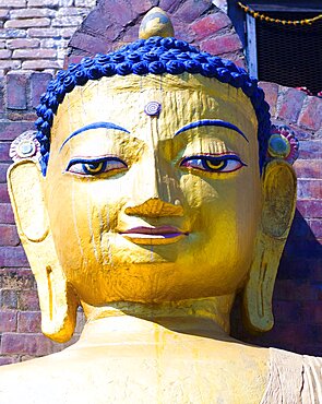 Nepal, Kathmandu, Beautiful golden Buddha head statue at theSwayambunath Monkey Temple.