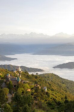 Nepal, Nagarkot, View across clouded valley towards Himalayan mountains.