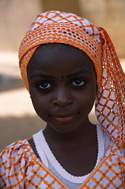 NIGERIA  Kano Portrait of girl wearing orange headscarf African Nigerian Western Africa