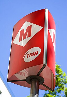 Spain, Catalonia, Barcelona, Red Metro sign against a blue sky.