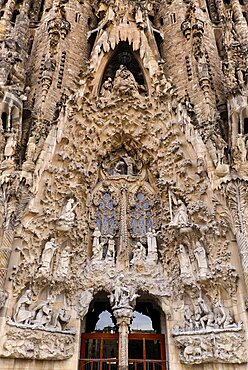 Spain, Catalunya, Barcelona, Basilica i Temple Expiatori de la Sagrada Familia, Generally known as Sagrada Familia, The Nativity facade showing the original detailed work of Antoni Gaudi.