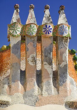 Spain, Catalunya, Barcelona, Antoni Gaudi's Casa Batllo building, colourful chimney pots on the roof terrace.