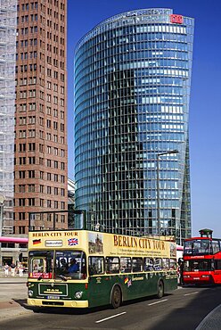 Germany, Berlin, Potzdamer Platz with Berlin City sightseeing tour bus in the foreground and Bahn Tower in the background.