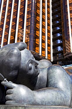 Spain, Madrid, Fernando Botero's statue of a fat lady lying down at Plaza de Colon.