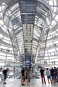 Germany, Berlin, Mitte, Tiergarten, interior of the glass dome on the top of the Reichstag building designed by architect Norman Foster with a double-helix spiral ramp around the mirrored cone that reflect light into the debating chamber of the Bundestag below.