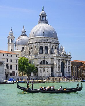 Italy, Venice, Church of Santa Maria della Salute from across the Grand Canal with a gondolas crossing  in the foreground.