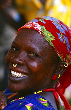 MALI  Body Decoration Smiling African woman wearing floral headscarf and small gold nose ring through her septum