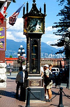 CANADA Vancouver Gastown The Gastown Steam Clock with people reading the inscriptions around the base