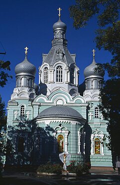 UKRAINE Odessa Pale green and white painted exterior facade of Ukrainian Orthodox Church with onion dome rooftops.