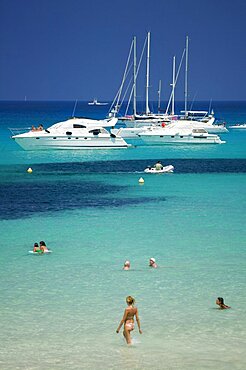 SPAIN Balearic Islands Ibiza Pleasure boats at Cala Saona  Formentera  with a few people swimming in the sea.   Tourism Holidays Beach Sunshine